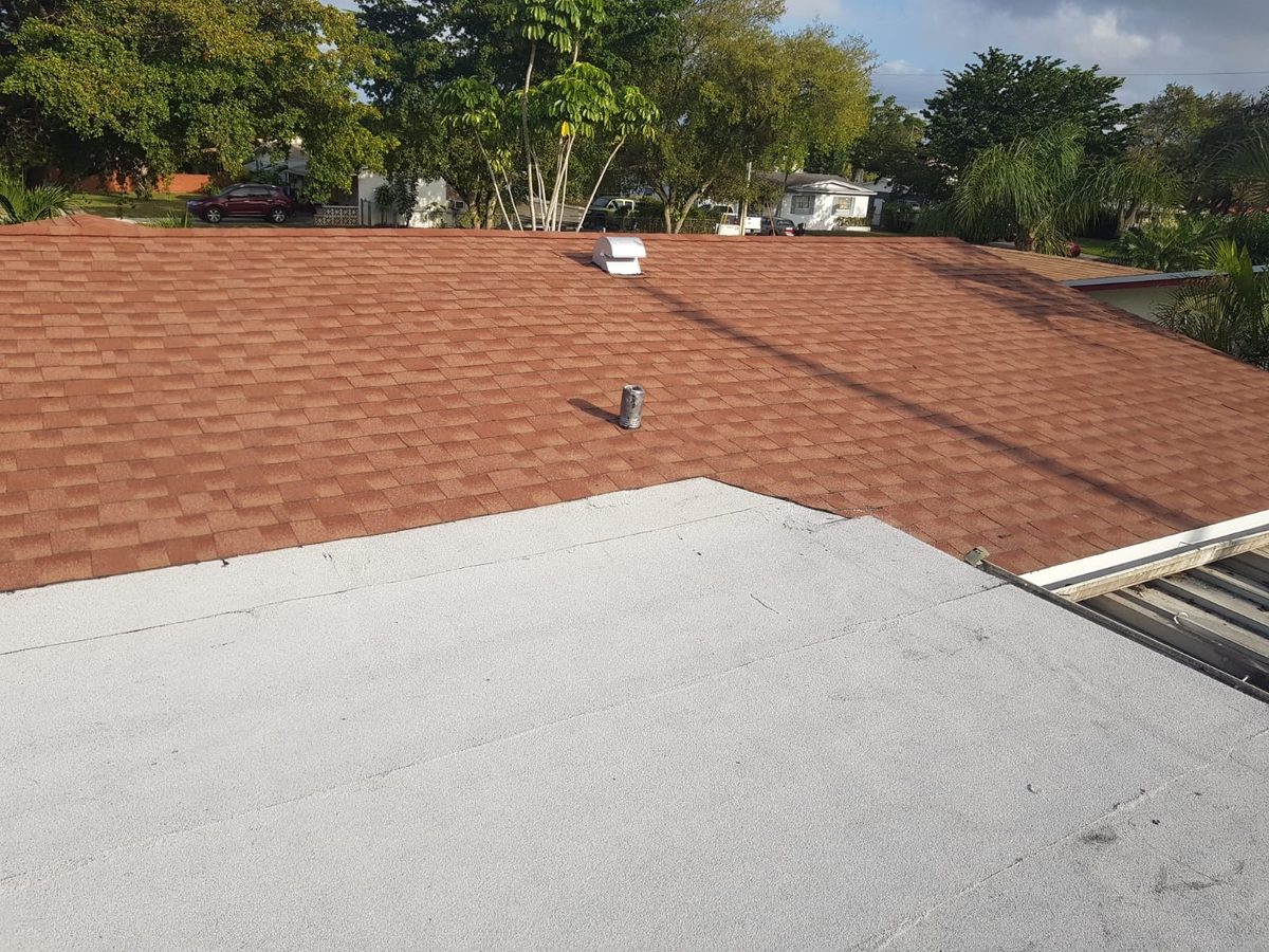 View of a newly installed brown shingle roof and adjacent white flat roof section.
