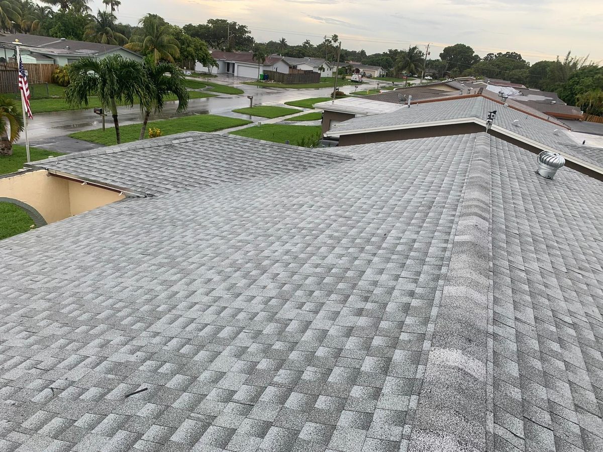 Newly installed grey shingles on a residential roof.