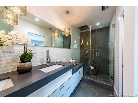 Modern bathroom vanity and glass shower enclosure.