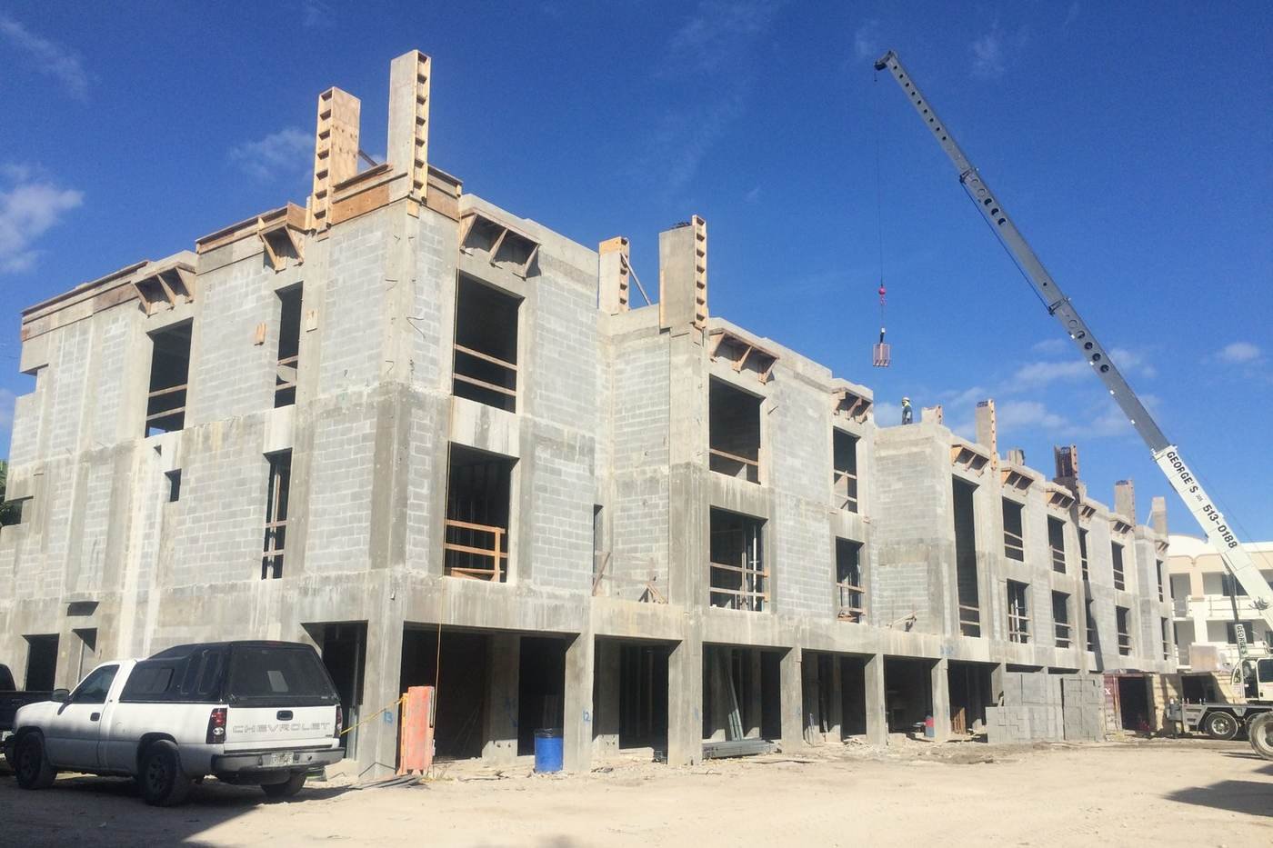Palma High-Grade commercial shell construction with crane — real project photo